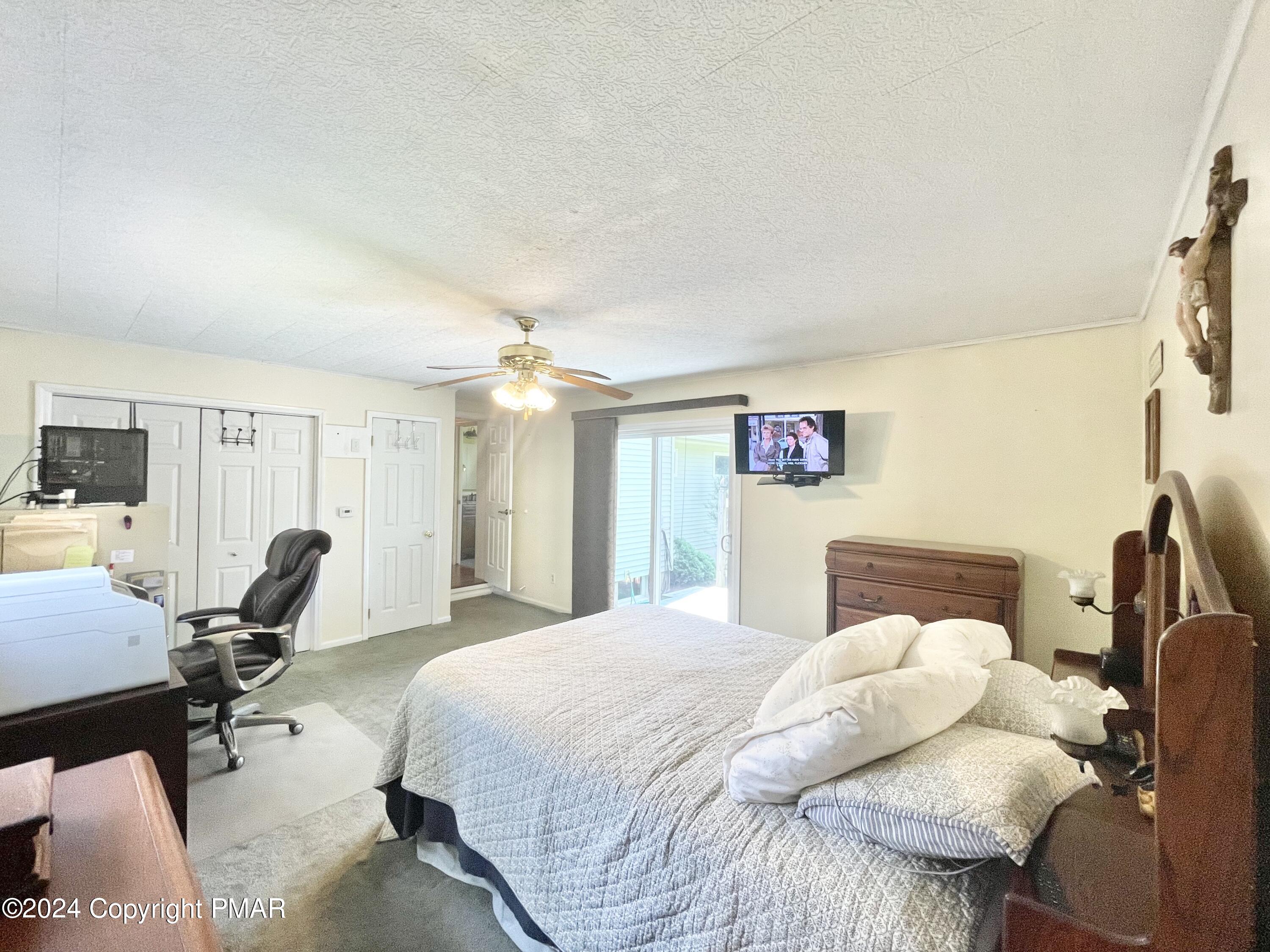 214 Shine Hill Road Henryville, PA 18332 - Photo 109 of 126 a bedroom with a bed a table and chair