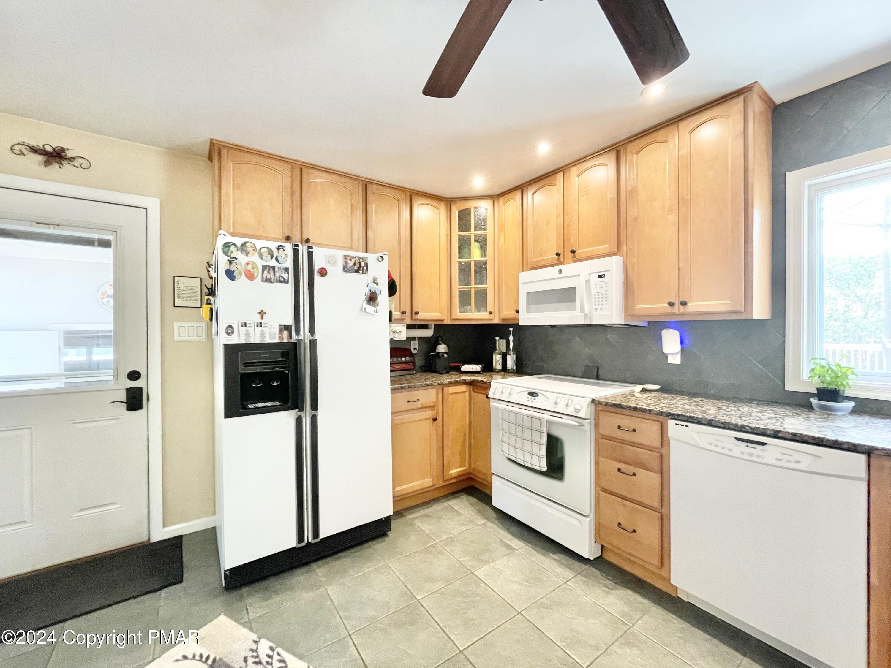 214 Shine Hill Road Henryville, PA 18332 - Photo 73 of 126 a kitchen with stainless steel appliances granite countertop a refrigerator sink and cabinets