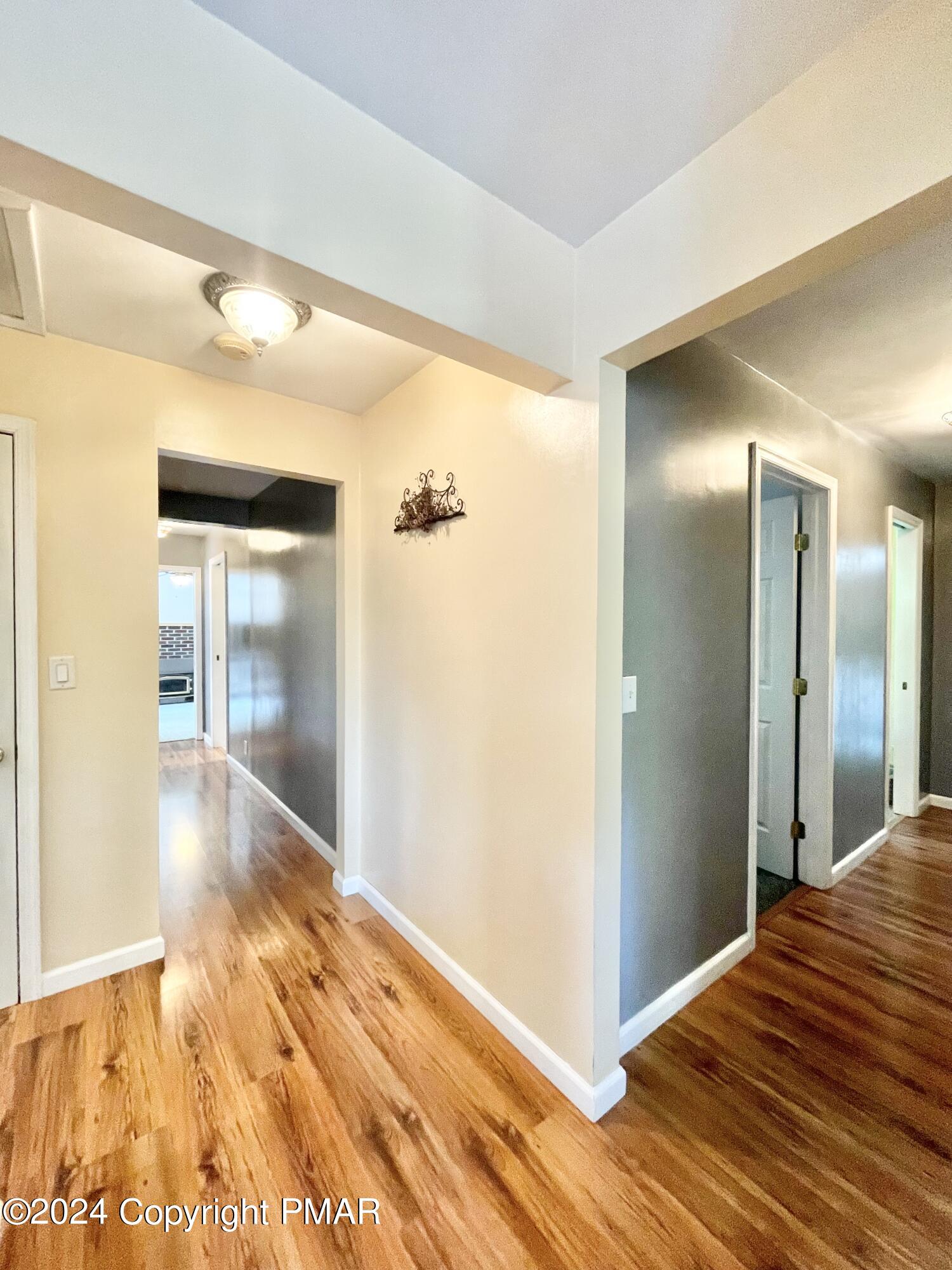 214 Shine Hill Road Henryville, PA 18332 - Photo 83 of 126 a view of a hallway with wooden floor and a bathroom