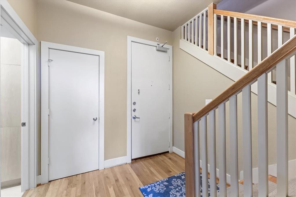 5055 Addison Circle, Unit 427 Addison, TX 75001 - Photo 4 of 35 a view of a hallway with wooden floor and staircase
