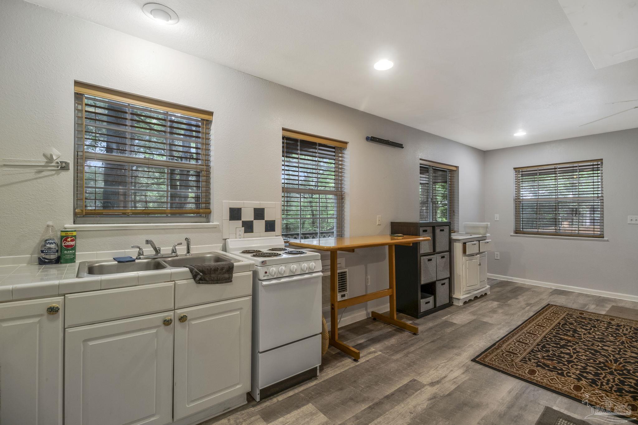 10290 West Lake Road Milton, FL 32583 - Photo 6 of 53 a kitchen with sink cabinets and appliances