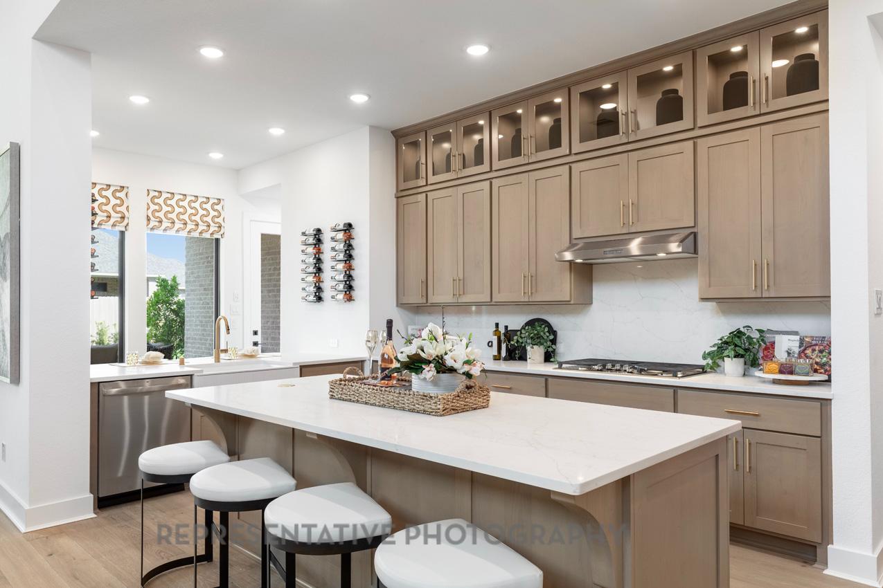 277 Leaning Rock Ridge Austin, TX 78737 - Photo 2 of 9 a kitchen with stainless steel appliances granite countertop a sink and a white cabinets