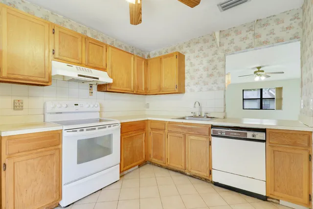 a kitchen with granite countertop cabinets stainless steel appliances and a sink
