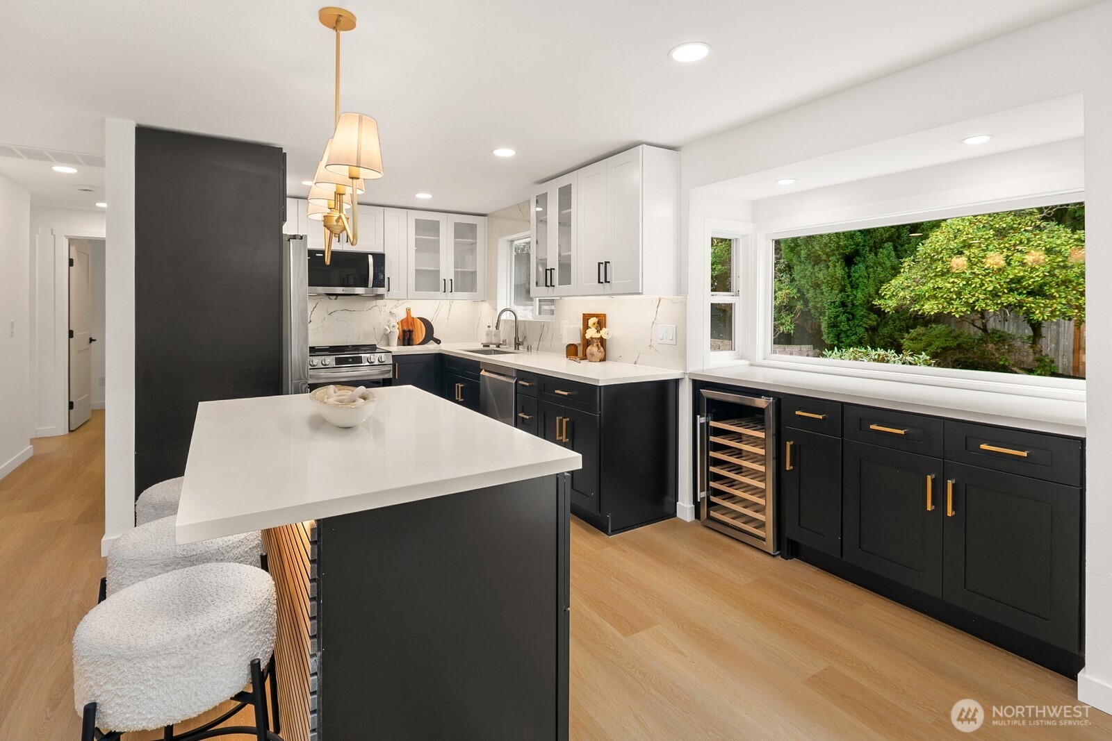 21807 3rd Place West Bothell, WA 98021 - Photo 10 of 32 a kitchen with stainless steel appliances kitchen island granite countertop a sink a stove and a refrigerator