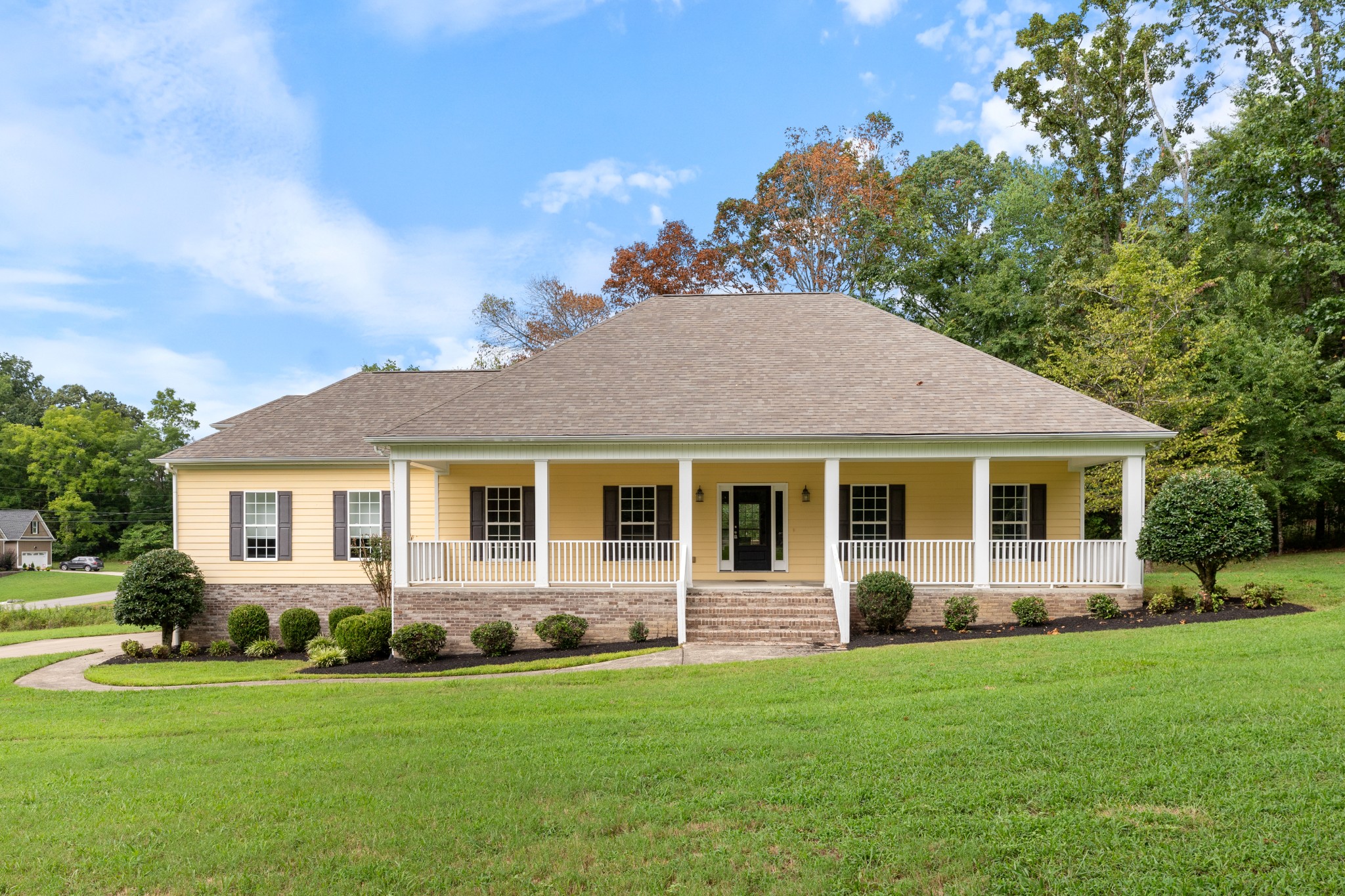 a front view of house with yard and green space