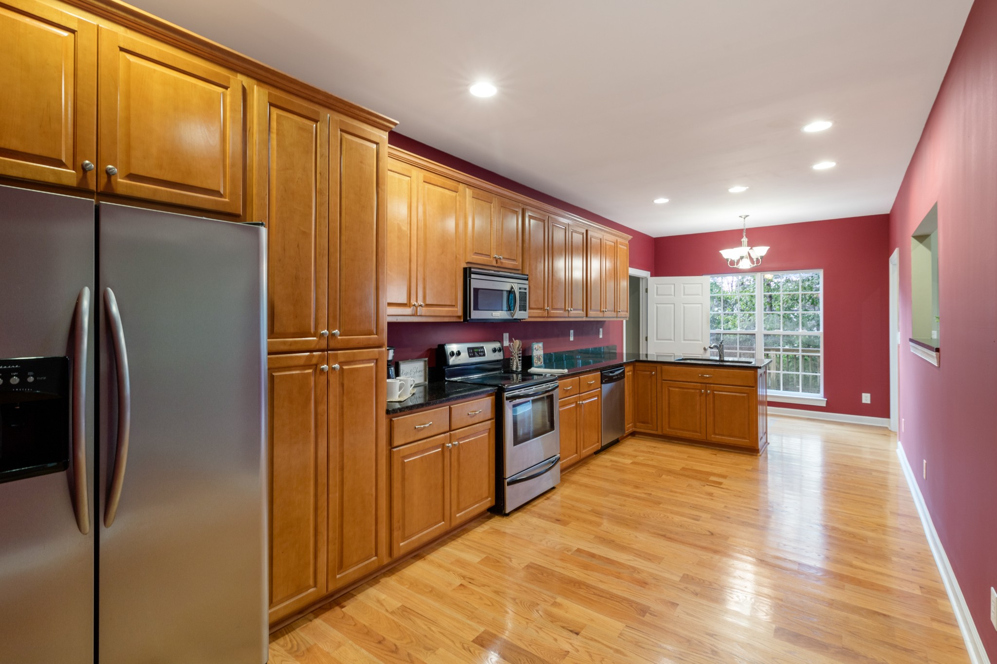 100 Kimberly Way Dickson, TN 37055 - Photo 14 of 34 a kitchen with stainless steel appliances granite countertop a refrigerator a sink and a stove