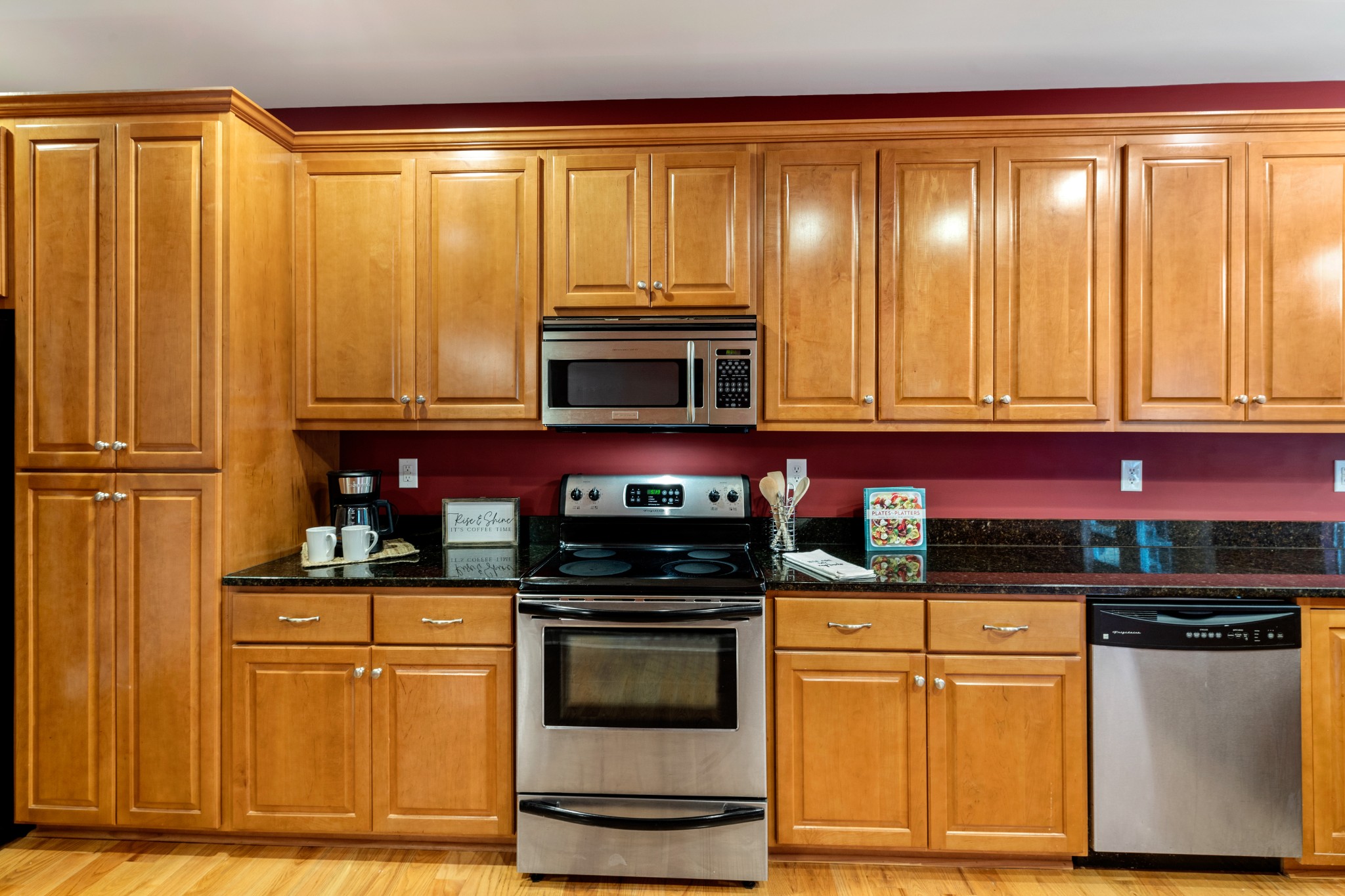 100 Kimberly Way Dickson, TN 37055 - Photo 17 of 34 a kitchen with stainless steel appliances granite countertop wooden cabinets and a stove top oven