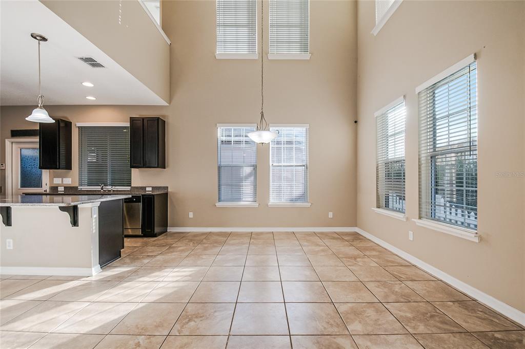 6844 Sundrop Street Harmony, FL 34773 - Photo 13 of 67 a view of kitchen with granite countertop cabinets and window