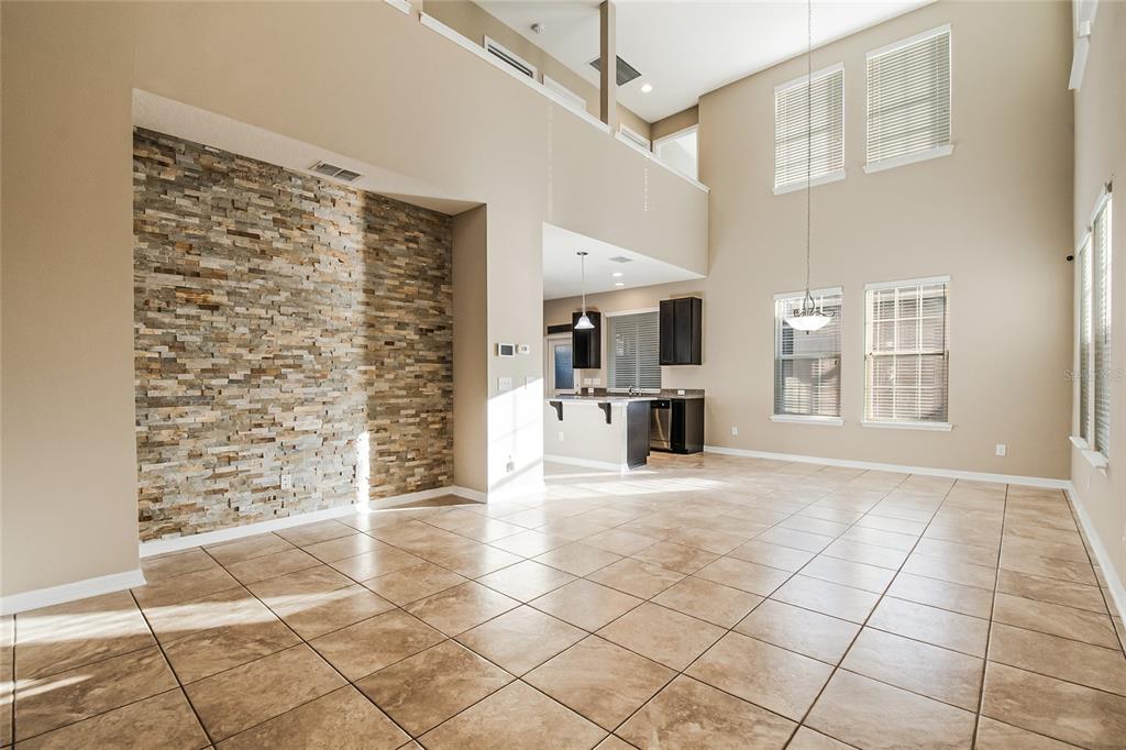 6844 Sundrop Street Harmony, FL 34773 - Photo 14 of 67 a view of empty room with wooden floor and fireplace