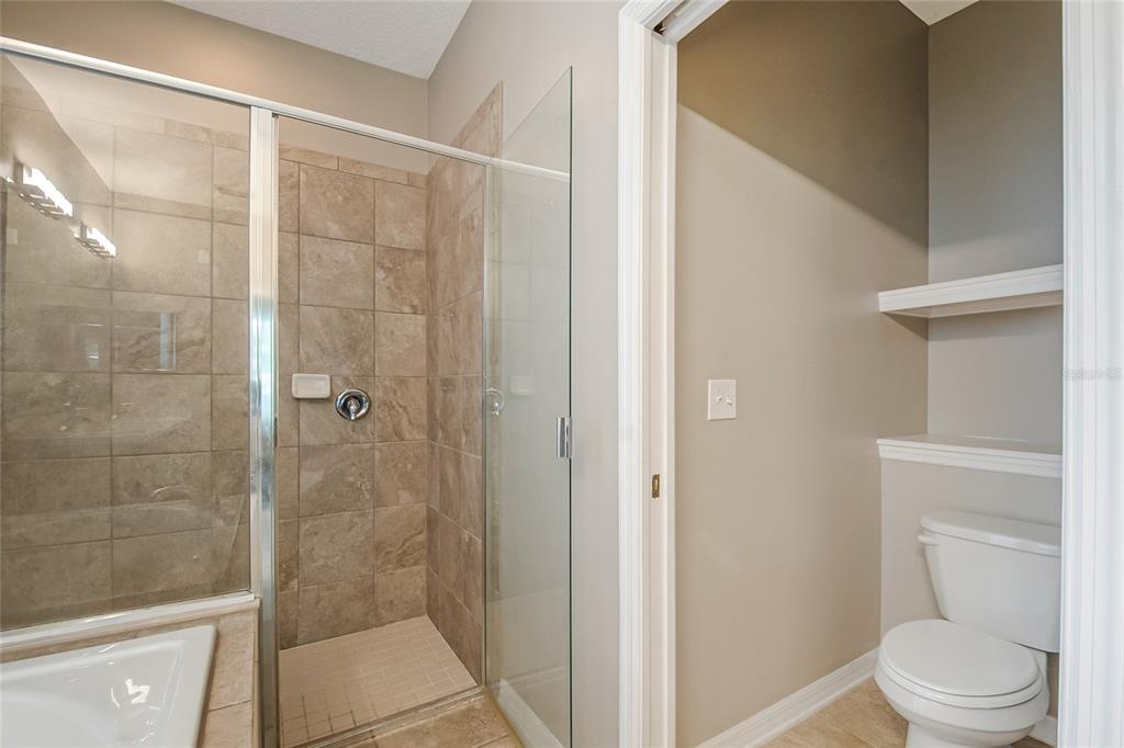 6844 Sundrop Street Harmony, FL 34773 - Photo 15 of 67 a bathroom with a toilet and a shower