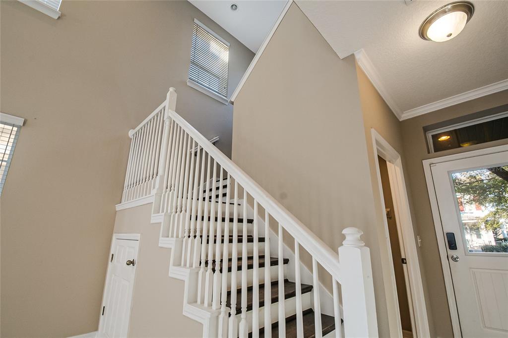 6844 Sundrop Street Harmony, FL 34773 - Photo 27 of 67 a view of staircase with railing and white walls