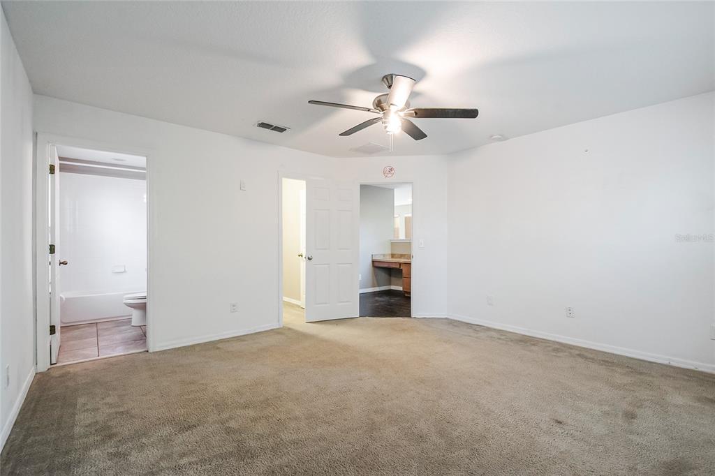 6844 Sundrop Street Harmony, FL 34773 - Photo 31 of 67 a view of an empty room and chandelier fan