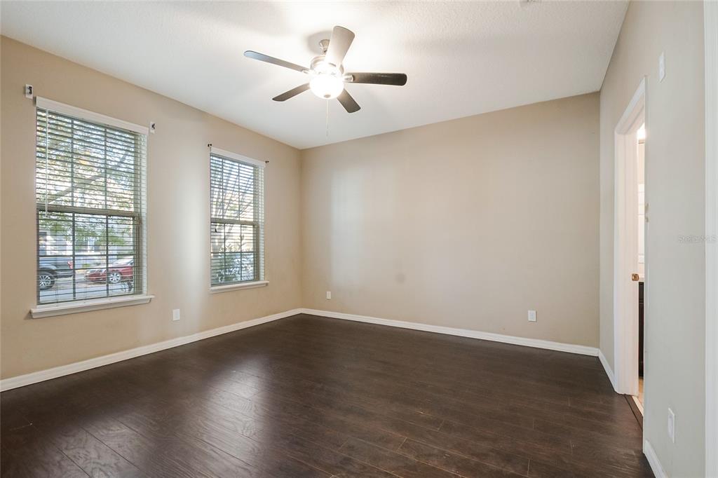 6844 Sundrop Street Harmony, FL 34773 - Photo 36 of 67 an empty room with wooden floor and windows