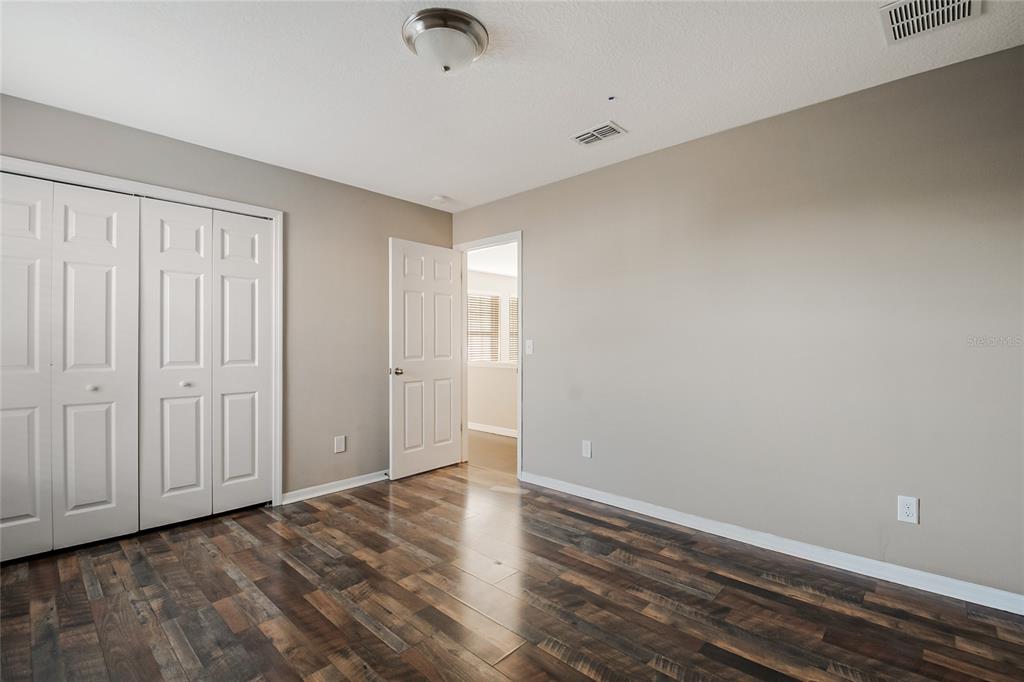 6844 Sundrop Street Harmony, FL 34773 - Photo 38 of 67 a view of an empty room with wooden floor