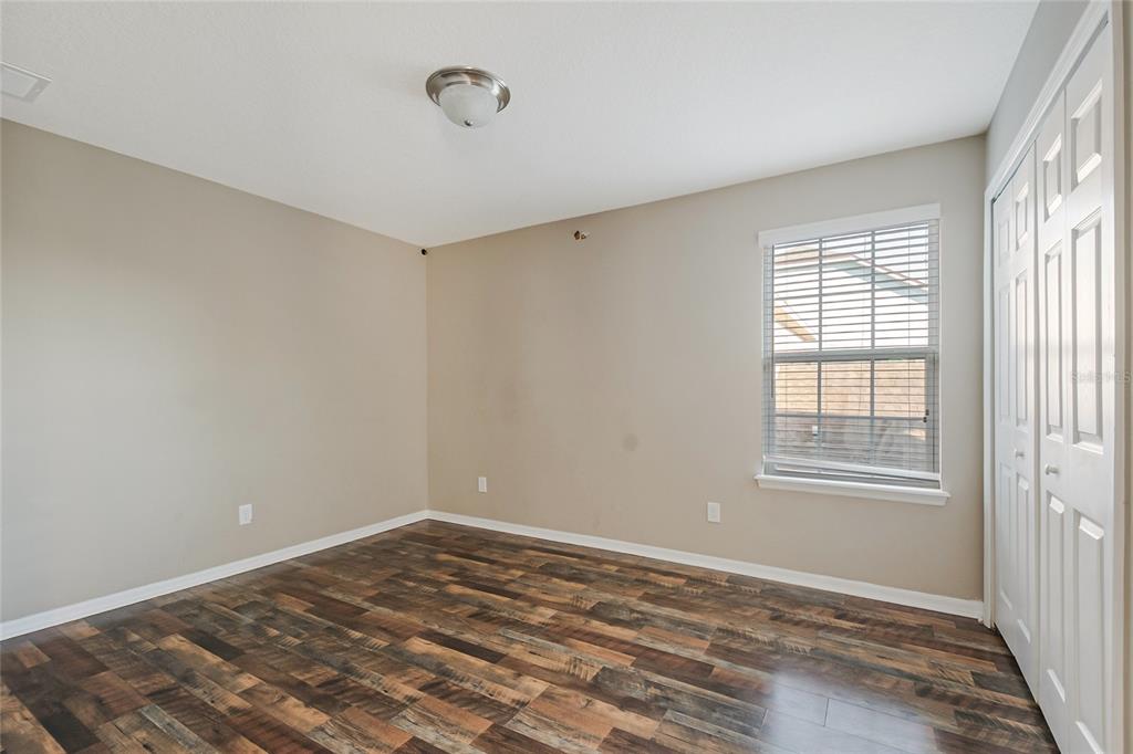 6844 Sundrop Street Harmony, FL 34773 - Photo 39 of 67 a view of a room with wooden floor and windows