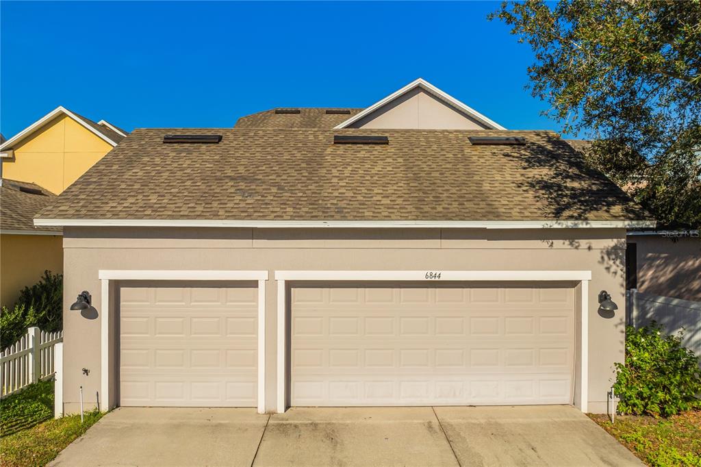 6844 Sundrop Street Harmony, FL 34773 - Photo 50 of 67 a front view of a house with garage