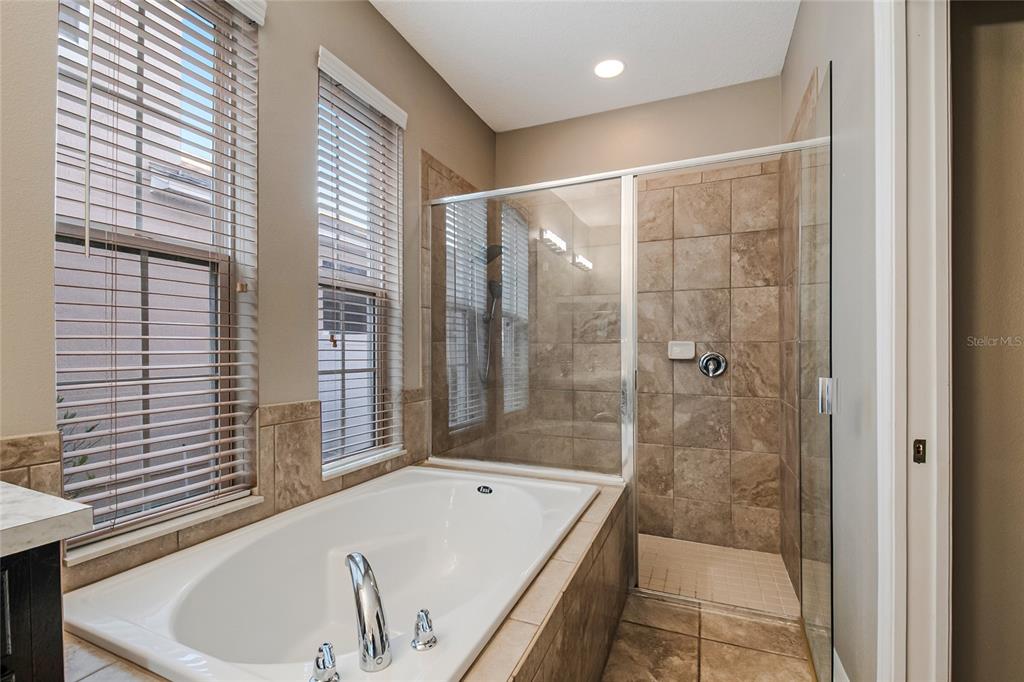 6844 Sundrop Street Harmony, FL 34773 - Photo 10 of 67 a bathroom with a bathtub and shower