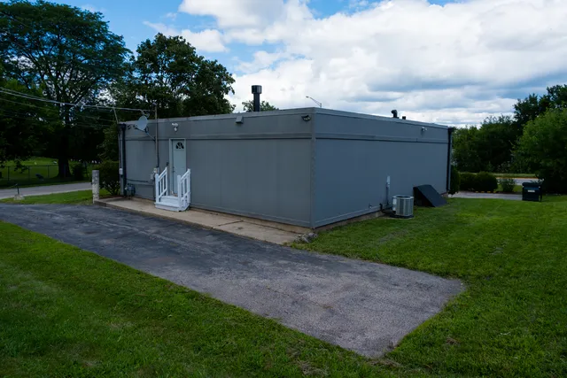 a backyard of a house with lots of green space and garden