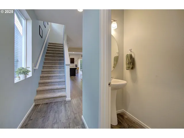 a view of entryway and hall with wooden floor