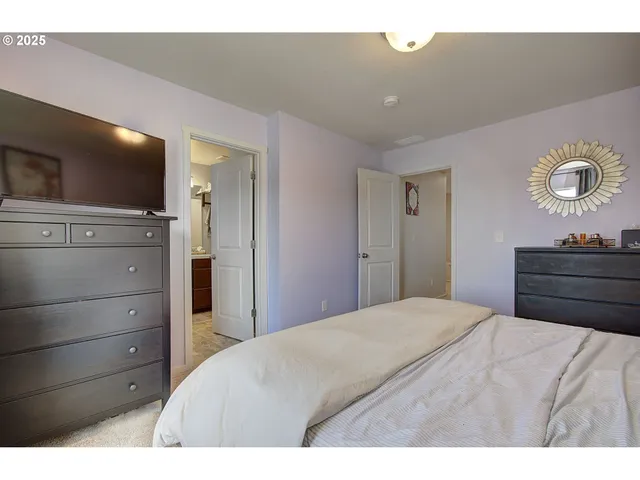 a bedroom with a bed and a television