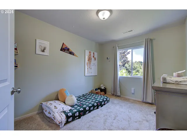 a bedroom with furniture and a window