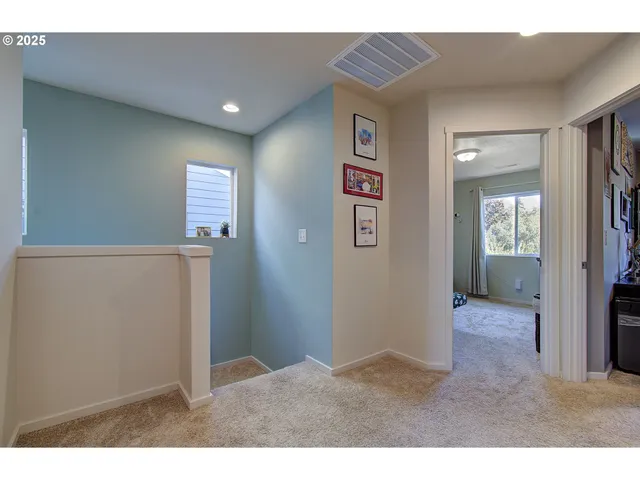 a view of hallway with bathroom