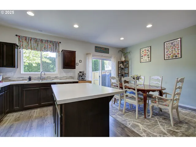 a kitchen with a table chairs and a refrigerator