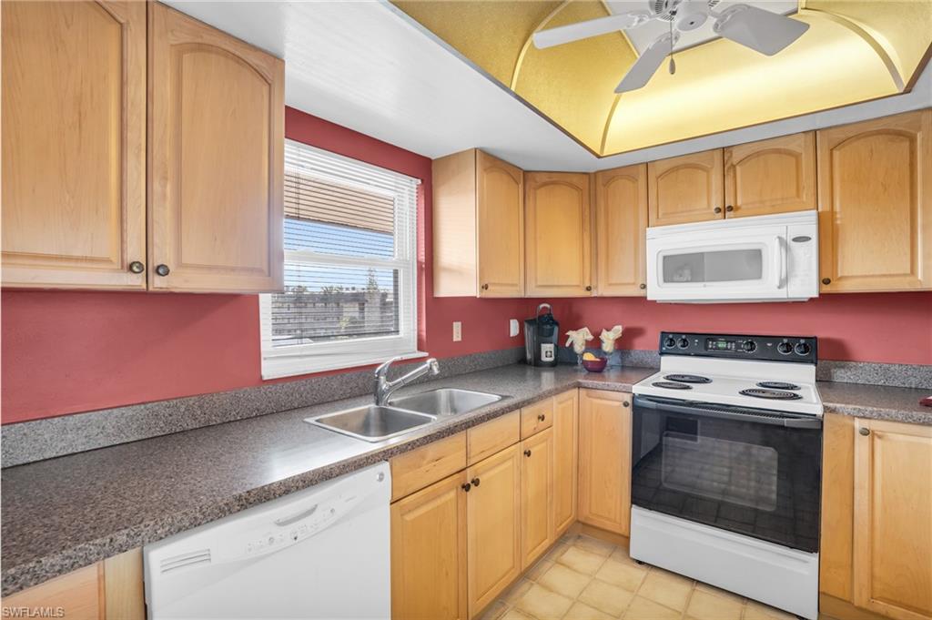5419 Rattlesnake Hamm Road, Unit 304F Naples, FL 34113 - Photo 4 of 15 UPDATED WARM WOOD CABINETRY, COORDINATING COUNTERS, AND NEWER IMPACT WINDOW...