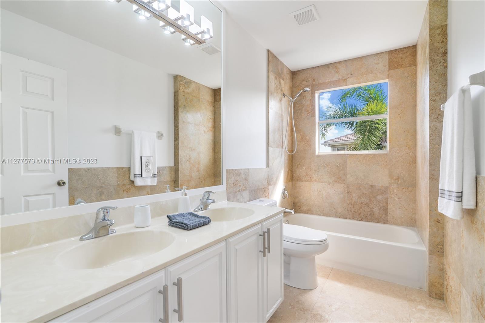 Silver Falls Miramar, FL 33027 - Photo 21 of 46 a bathroom with a double vanity sink toilet and shower
