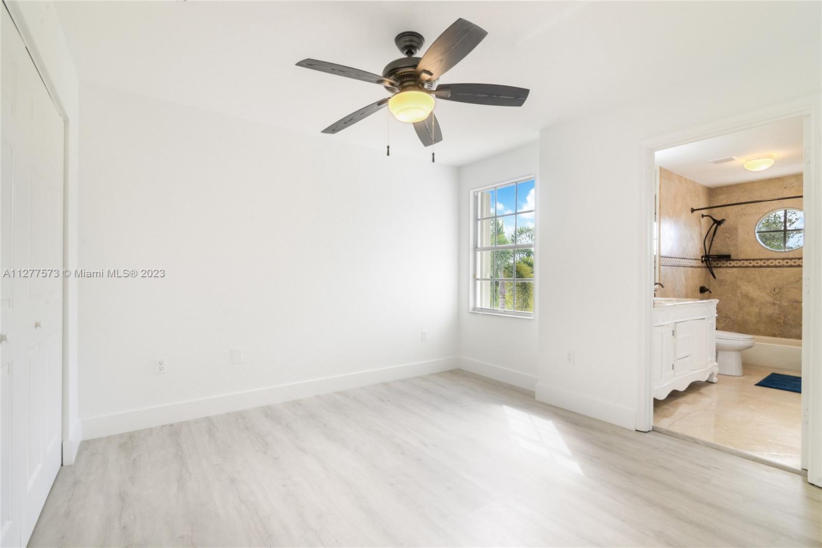 Silver Falls Miramar, FL 33027 - Photo 23 of 46 an empty room with a window and a ceiling fan