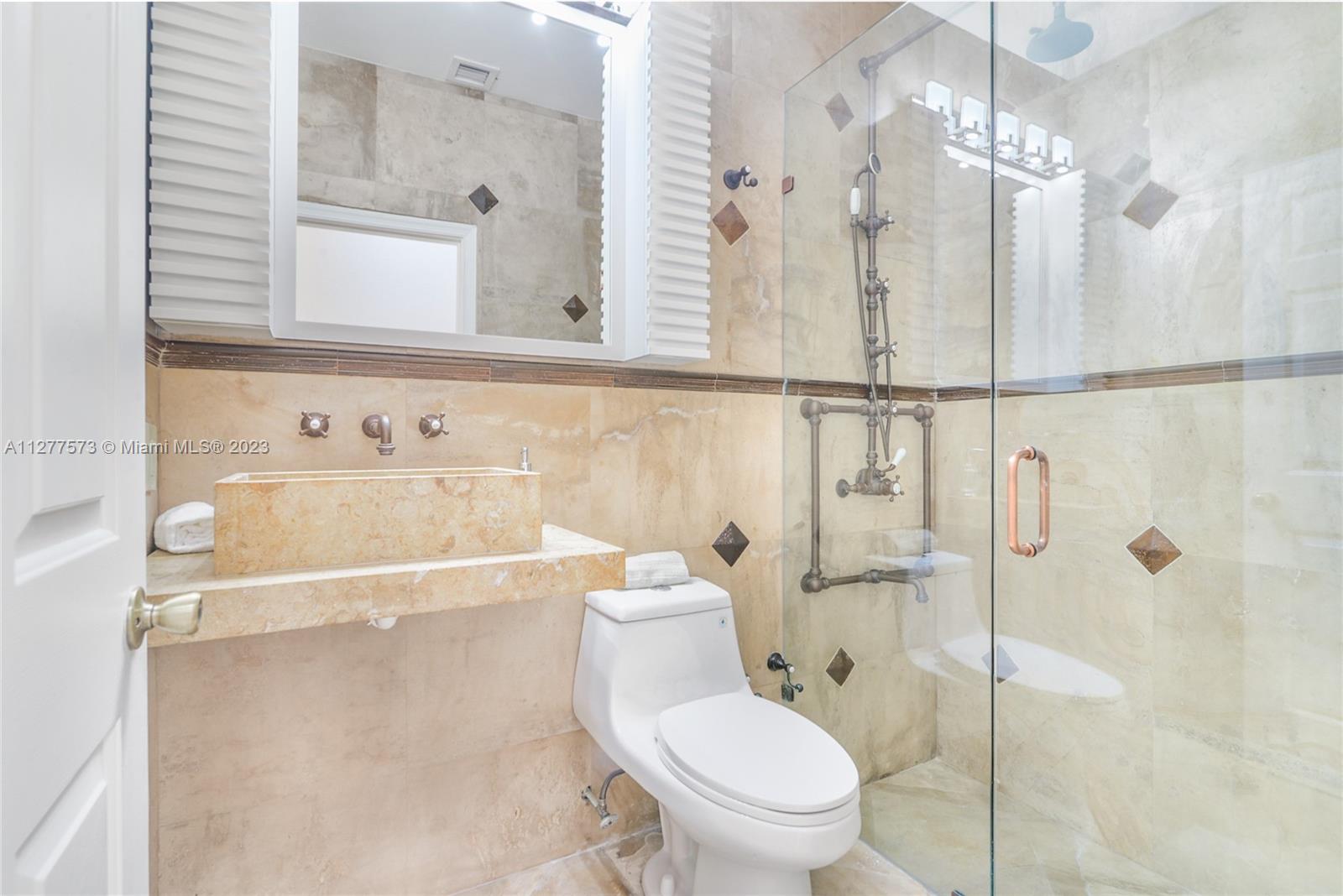 Silver Falls Miramar, FL 33027 - Photo 27 of 46 a bathroom with a toilet sink shower and mirror