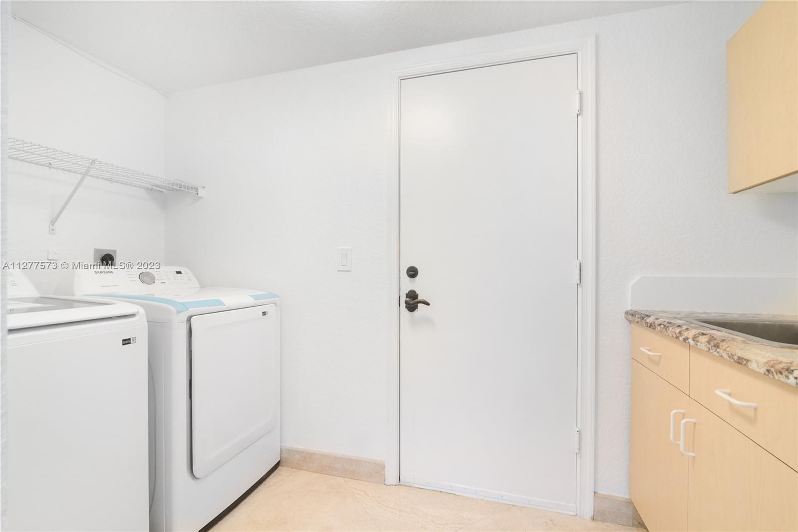 Silver Falls Miramar, FL 33027 - Photo 28 of 46 a utility room with cabinets washer and dryer