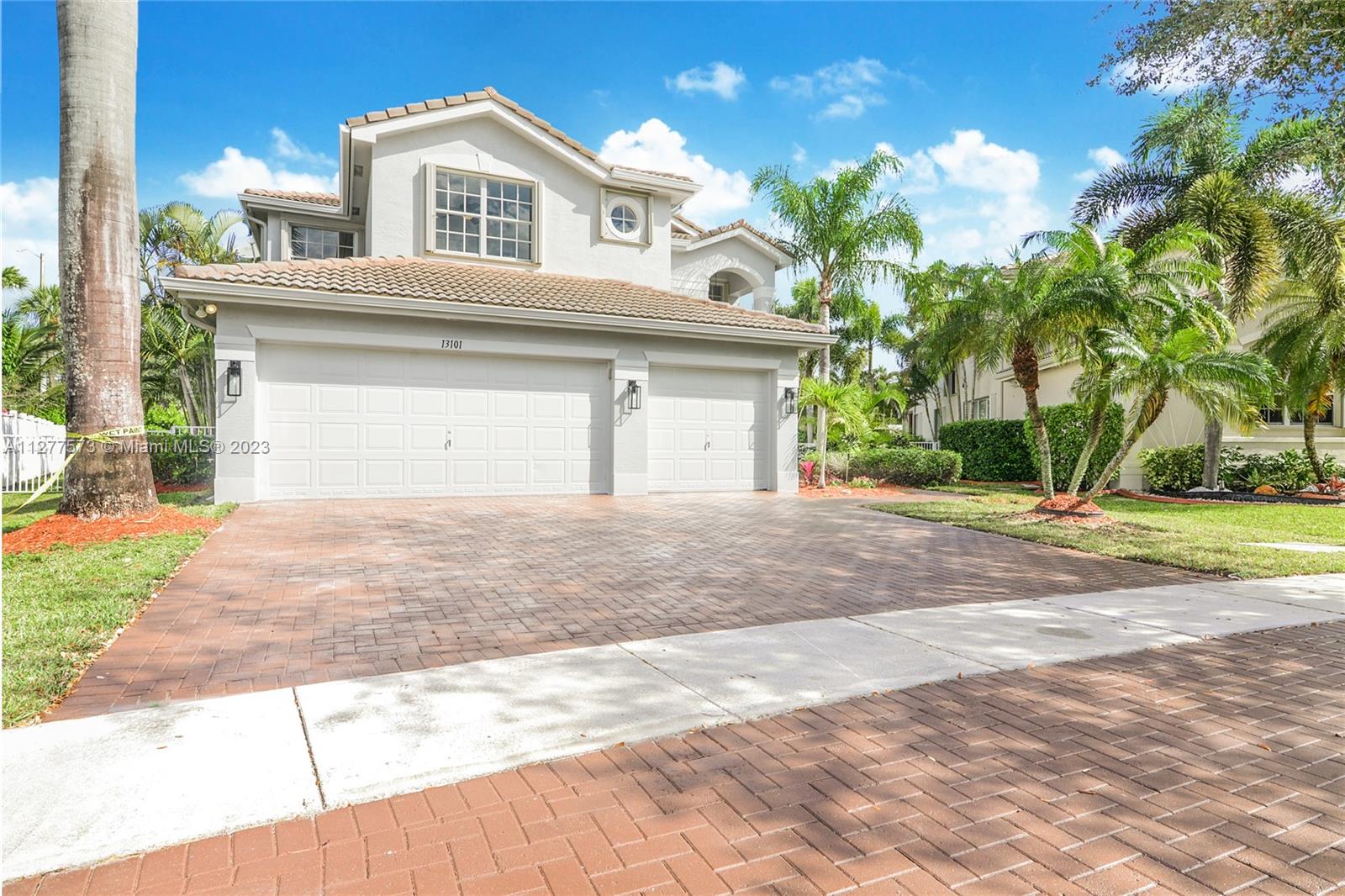 Silver Falls Miramar, FL 33027 - Photo 30 of 46 a view of a white house with a yard and plants