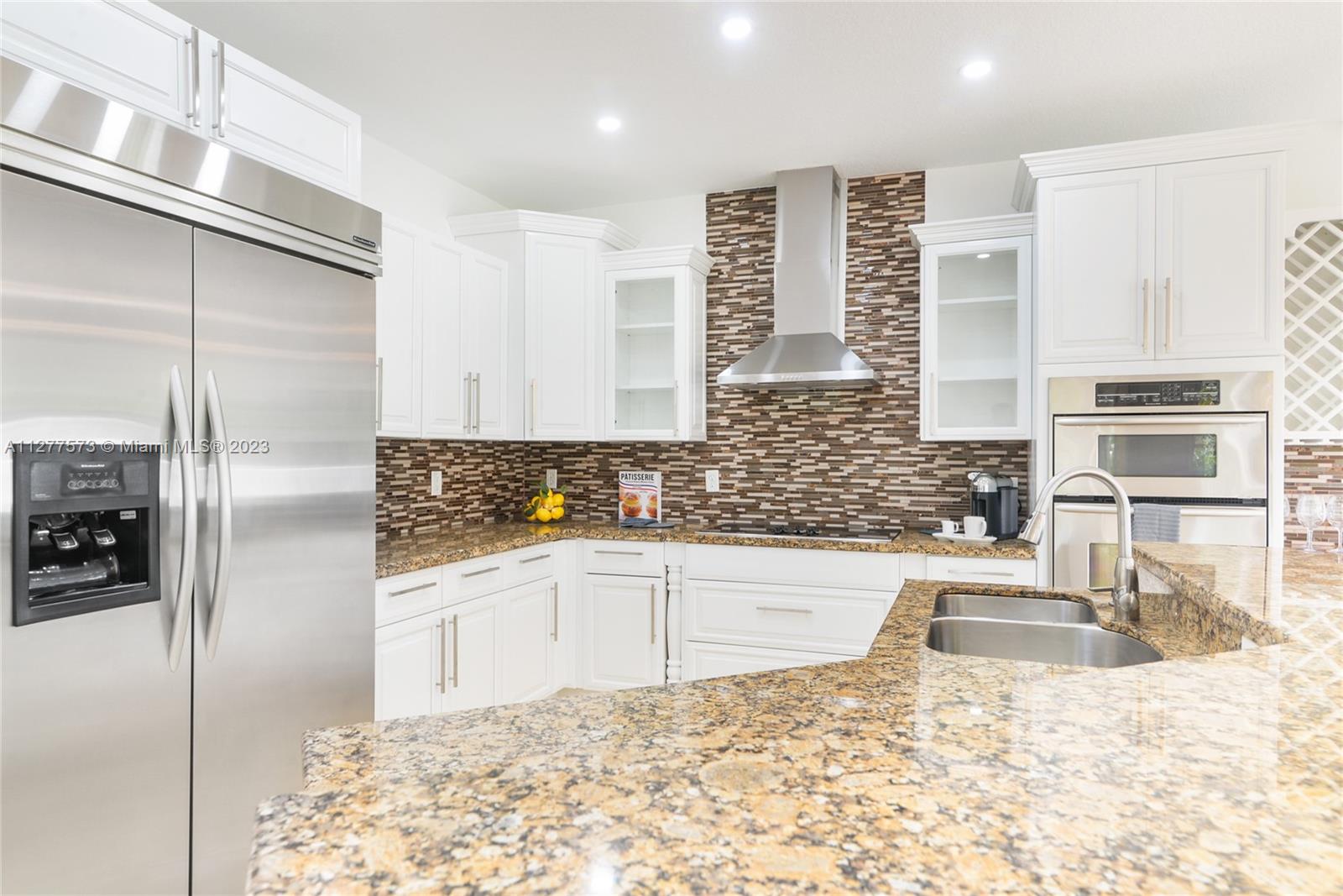 Silver Falls Miramar, FL 33027 - Photo 7 of 46 a kitchen with granite countertop a refrigerator and a sink