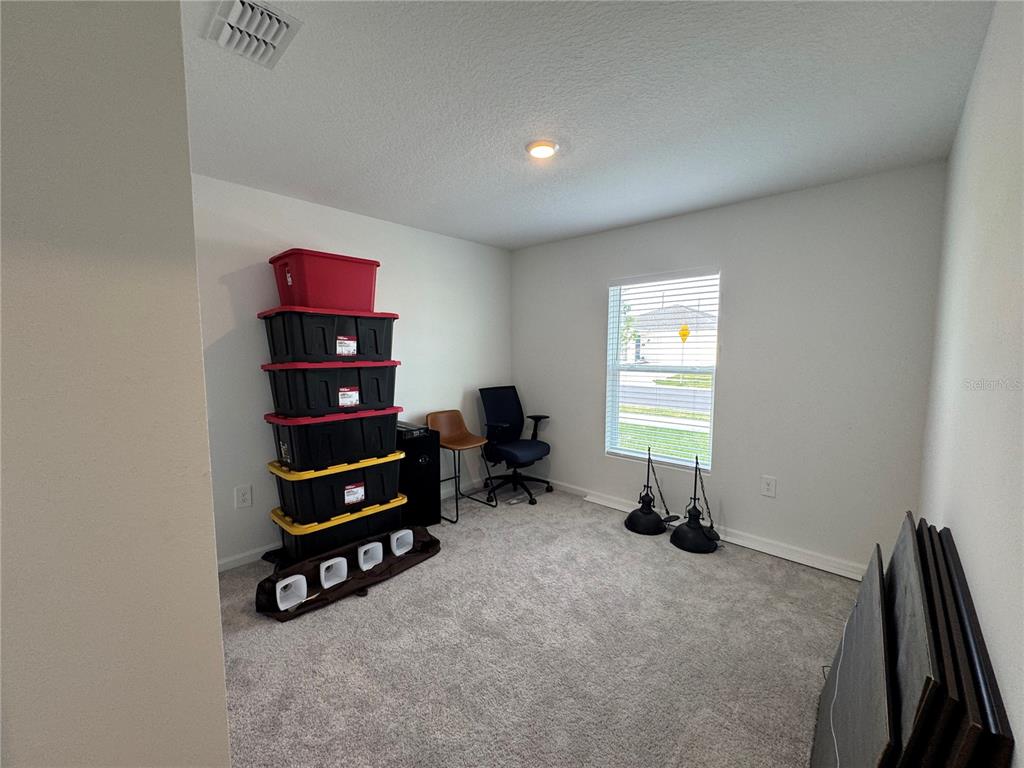 2405 Bluestone Road Haines City, FL 33844 - Photo 12 of 18 a room with furniture and a window