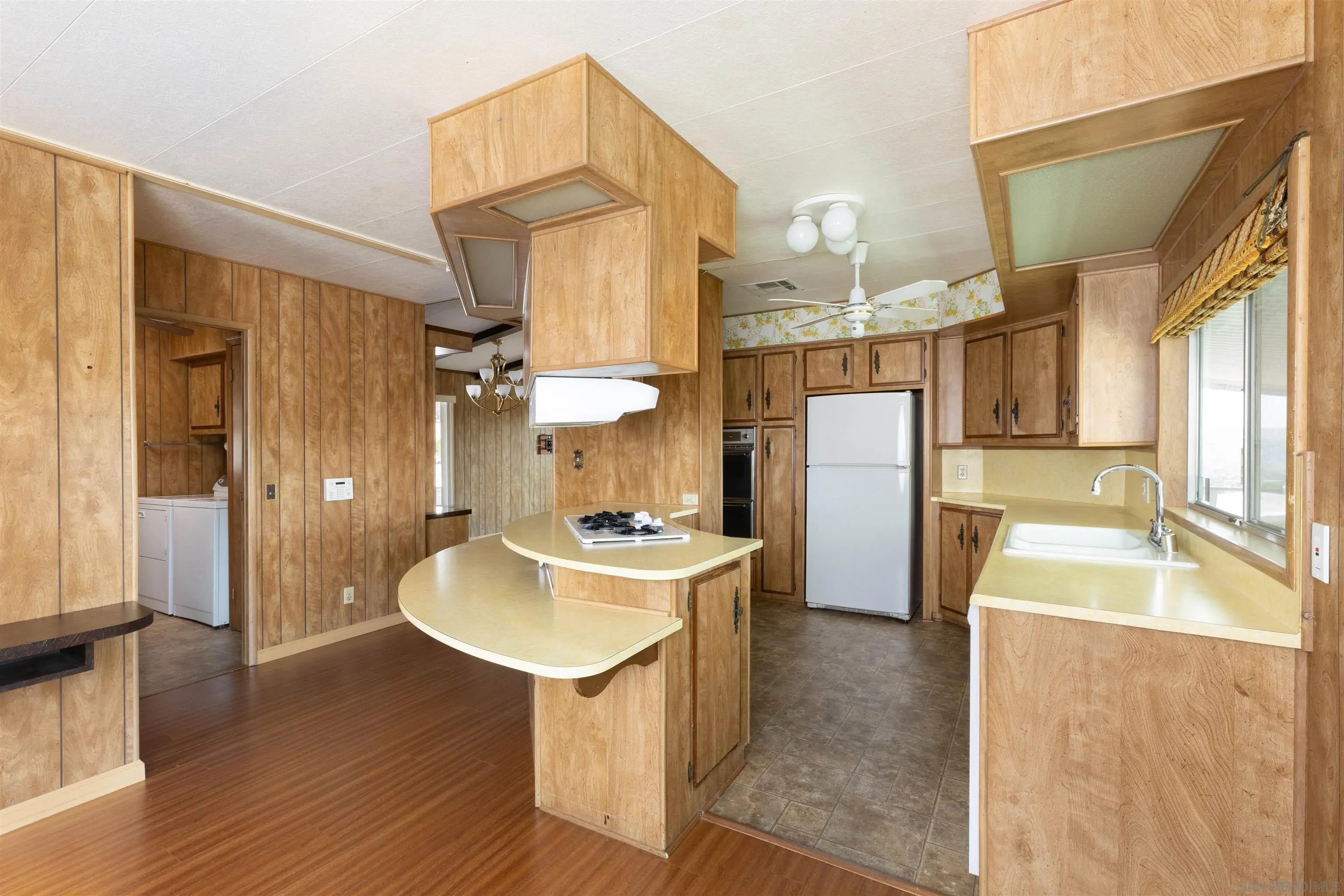 275 South Worthington Street, Unit 105 Spring Valley, CA 91977 - Photo 11 of 25 a kitchen with a sink a refrigerator and a stove