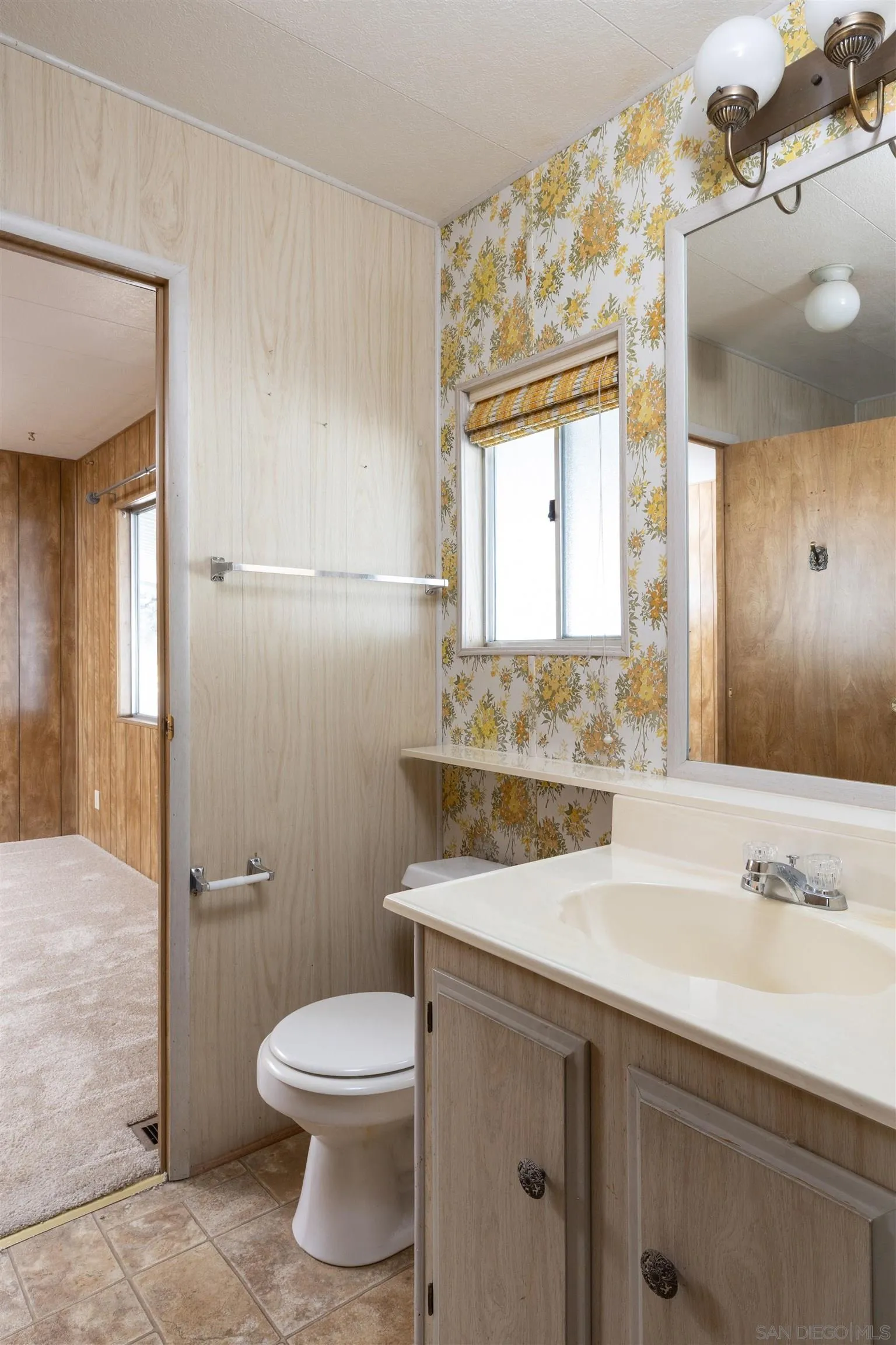 275 South Worthington Street, Unit 105 Spring Valley, CA 91977 - Photo 18 of 25 a bathroom with a sink toilet and mirror