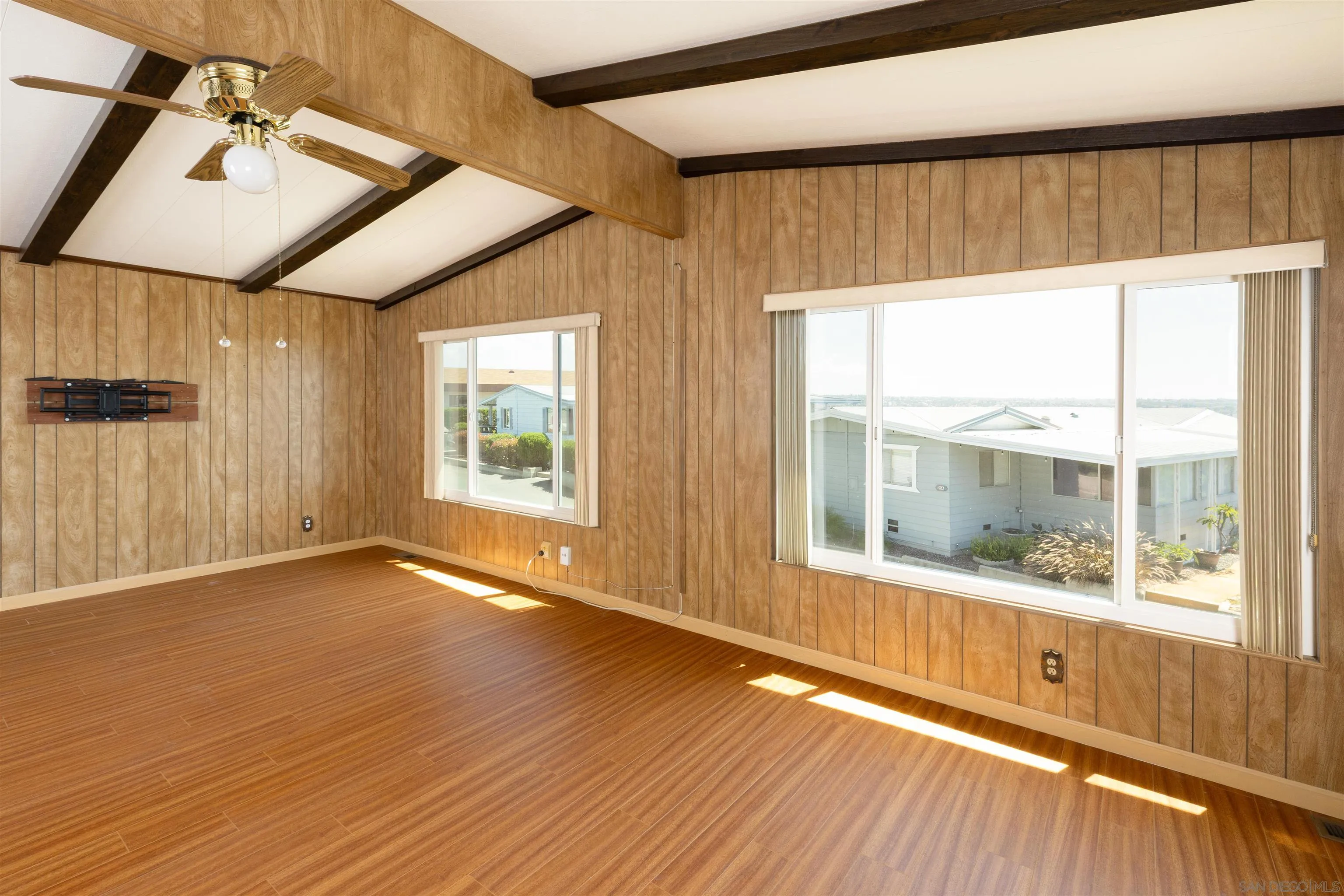 275 South Worthington Street, Unit 105 Spring Valley, CA 91977 - Photo 6 of 25 a view of an empty room with wooden floor and a window