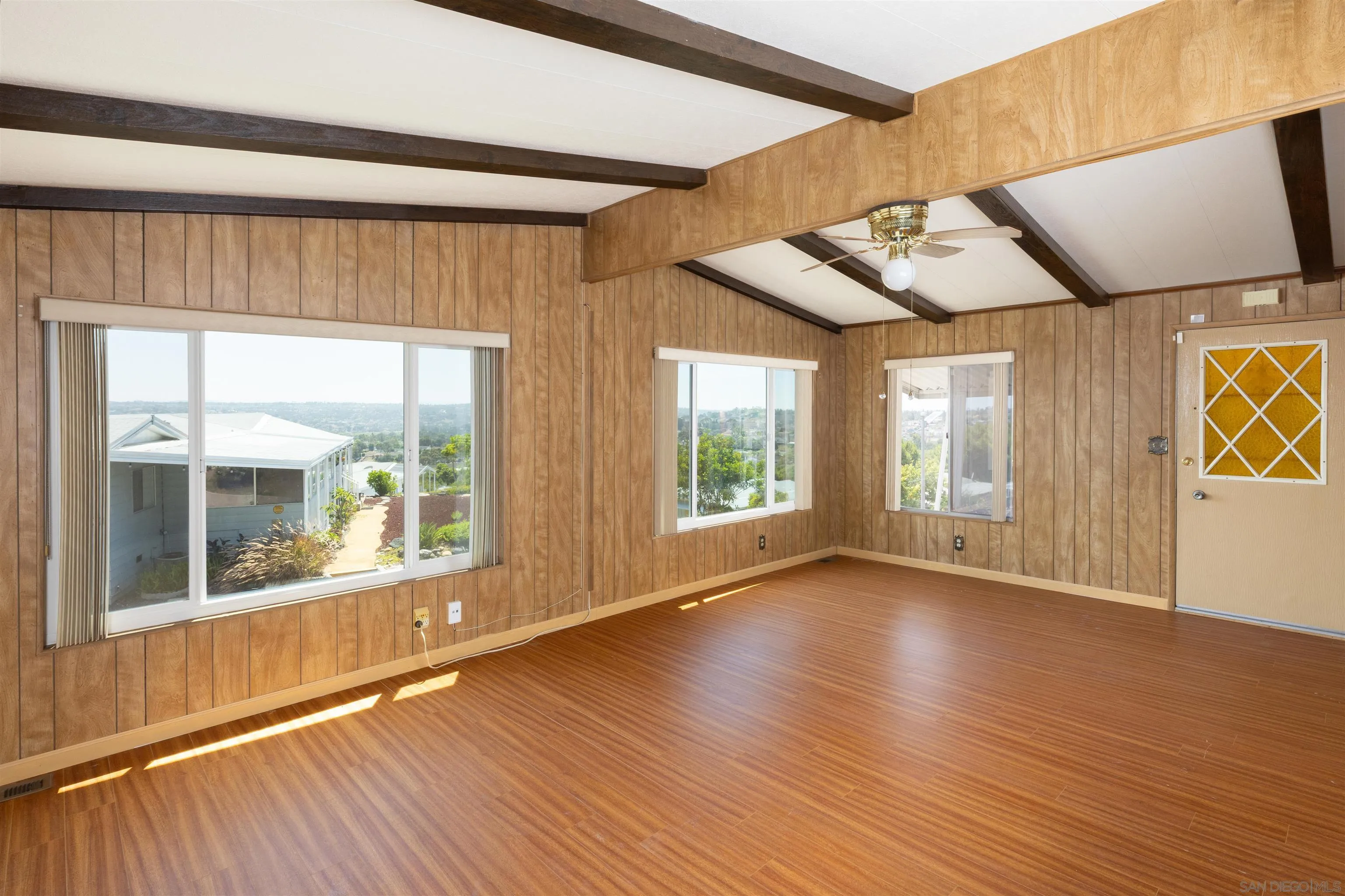 275 South Worthington Street, Unit 105 Spring Valley, CA 91977 - Photo 7 of 25 a view of an empty room with wooden floor and a window