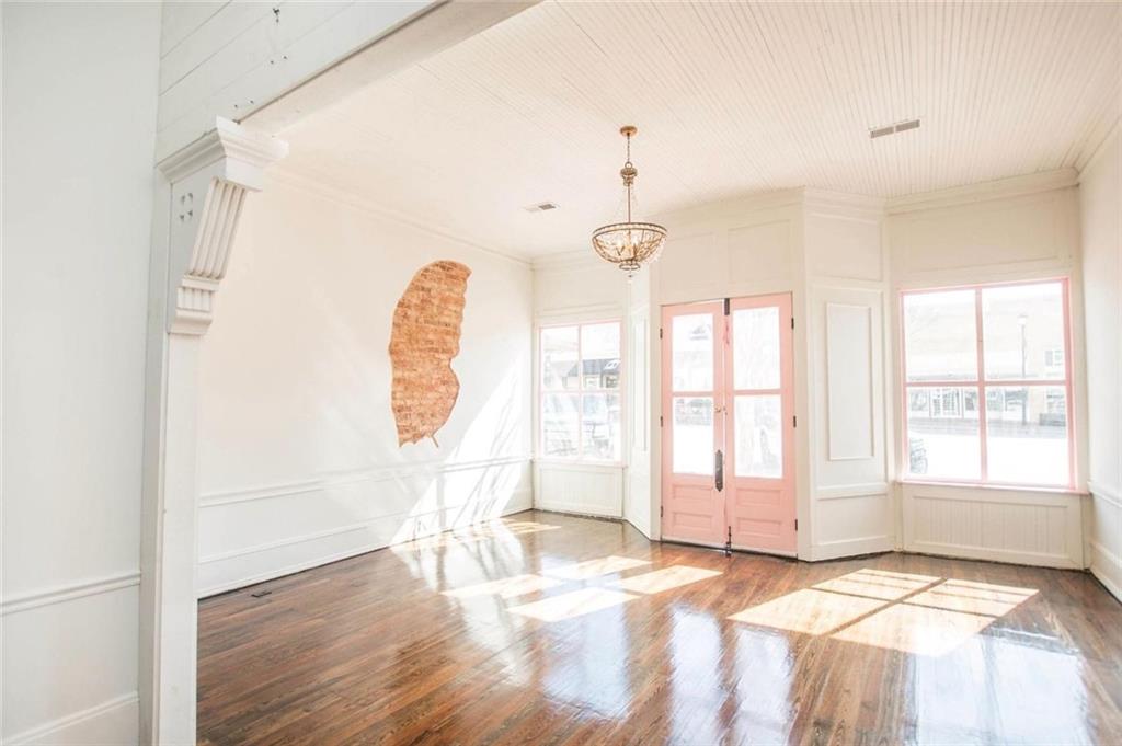 145 South Cherokee Road Social Circle, GA 30025 - Photo 3 of 13 a view of an empty room with a window and wooden floor