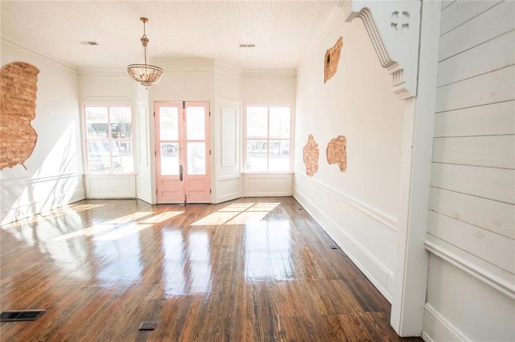 145 South Cherokee Road Social Circle, GA 30025 - Photo 4 of 13 a view of an empty room with wooden floor and a window