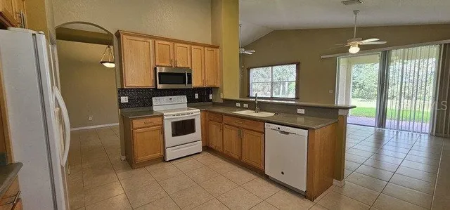 a kitchen with a stove sink and microwave