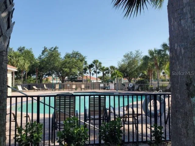 view of a swimming pool with a yard