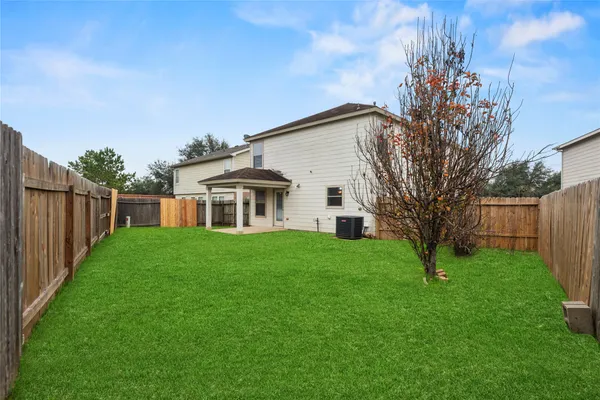 a view of a house with a yard and sitting area