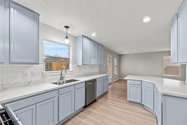 a kitchen with stainless steel appliances granite countertop a white stove top oven sink and cabinets