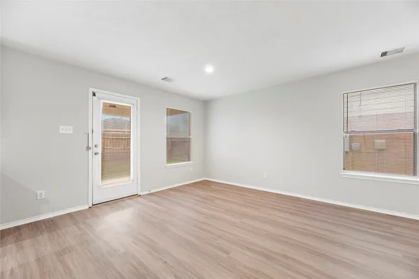 a kitchen with a sink cabinets and wooden floor