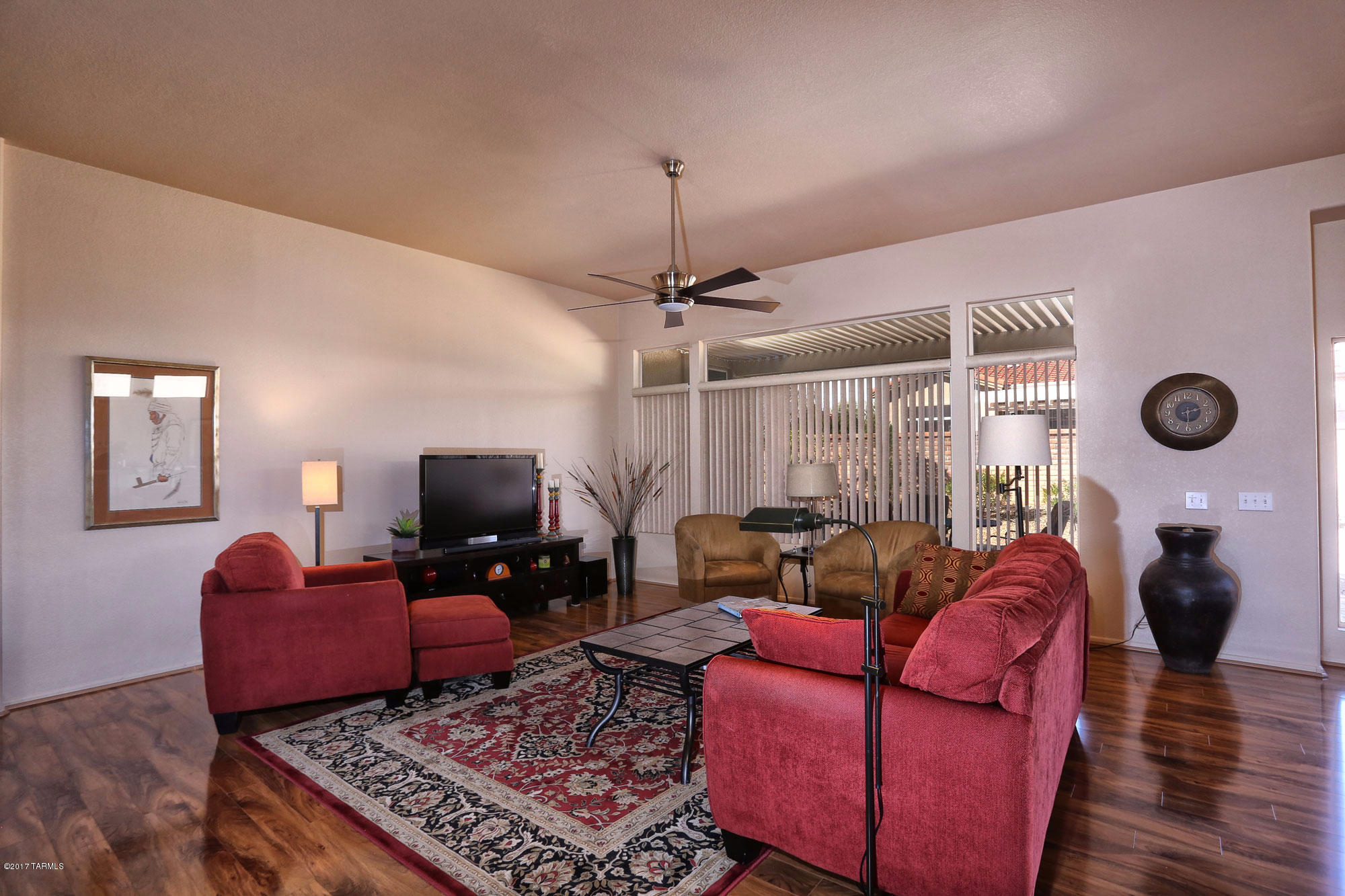 1065 East Royal Oak Road Oro Valley, AZ 85755 - Photo 7 of 19 a living room with furniture a flat screen tv and a window