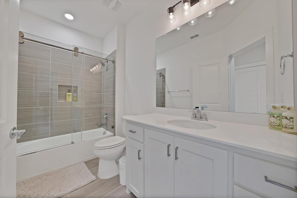 1010 Adair Road Prosper, TX 75078 - Photo 24 of 39 a bathroom with a sink toilet tub and shower