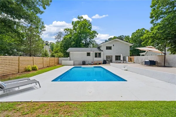 a view of a white house with a yard
