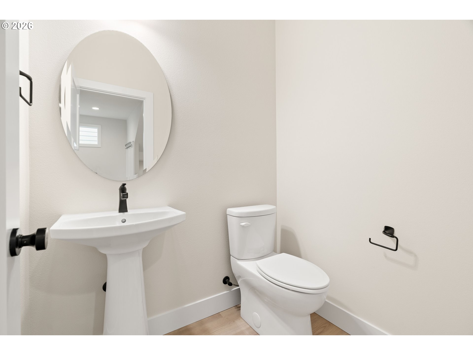 2876 Northwest 114th Terrace Portland, OR 97229 - Photo 3 of 32 a bathroom with a toilet a sink and mirror